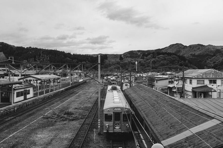 A small rural mountain station with platform and surrounding hills