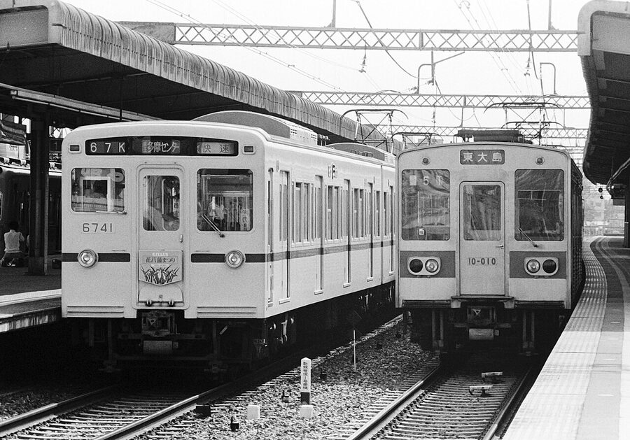 Keio 6000 series and Toei 10-000 series prototype at Sasazuka Station, June 1983