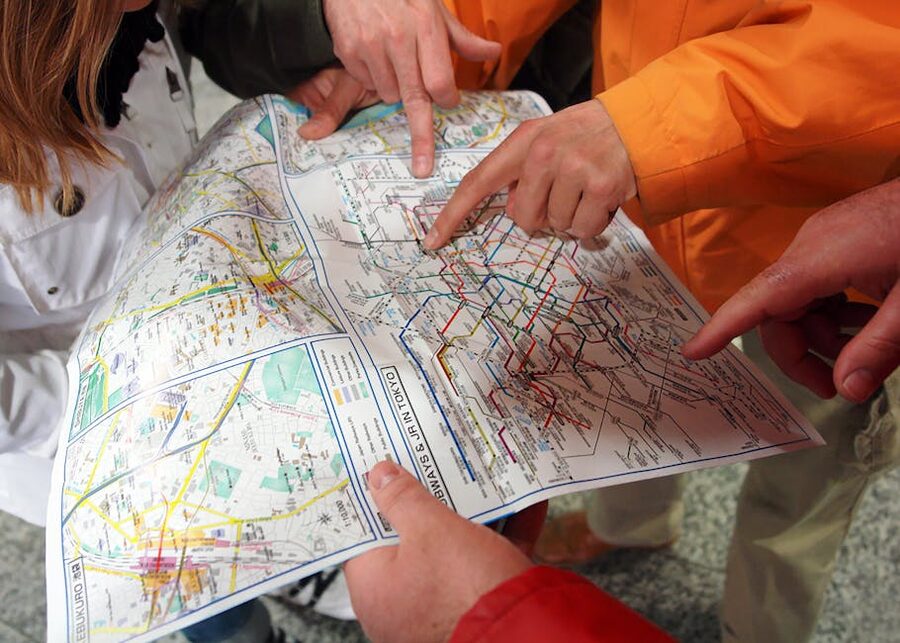 Tourists examining a Tokyo subway map at a station concourse