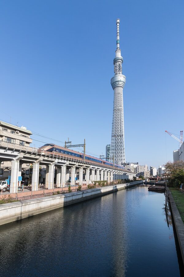 Tokyo Skytree with Tobu 100 Spacia in Nikko-mode purple-and-gold livery