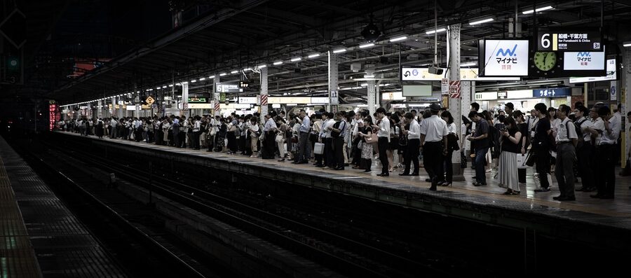 Shibuya area at night with people and trains