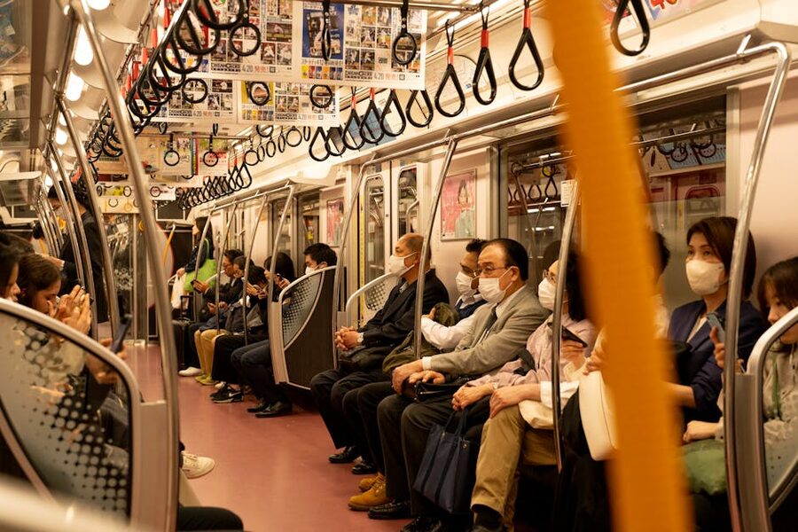 Passengers sitting in a Tokyo subway train carriage