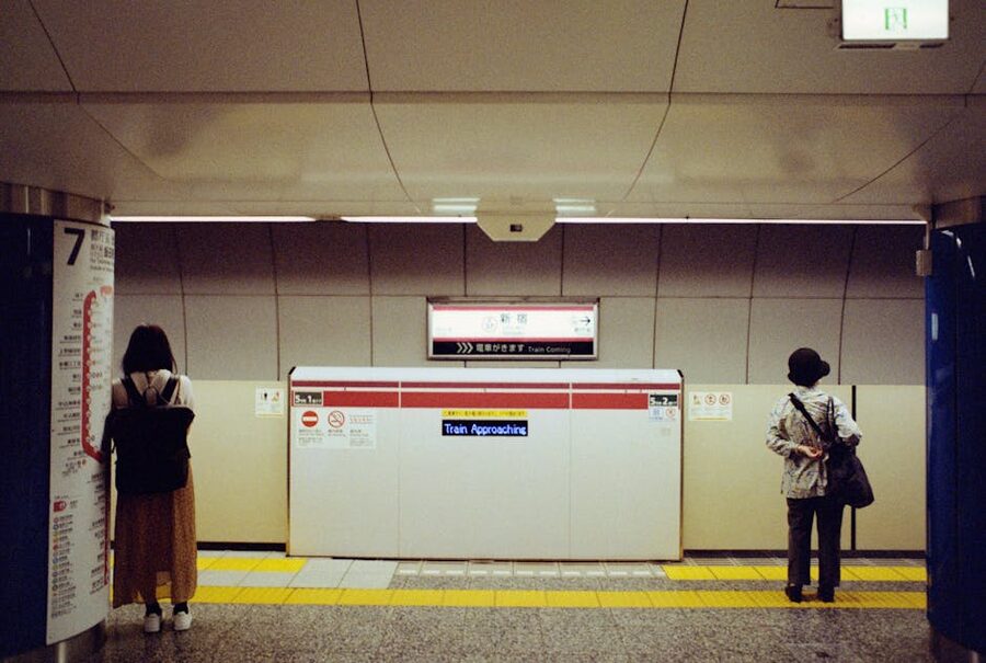 Travelers waiting at a Tokyo subway station platform