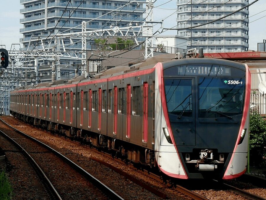 Toei 5500 series at Asakusa Line in rose-pink and black livery