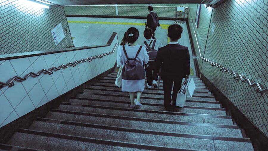 People walking down stairs at Tokyo subway station